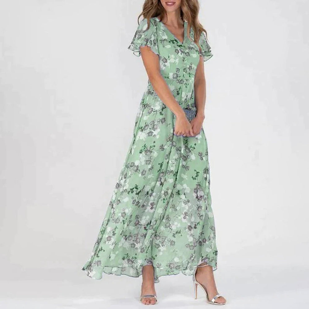 Kvinne i lang, grønn blomsterkjole med korte ermer og v-hals. Perfekt for sommer, mote, stil, elegant antrekk.