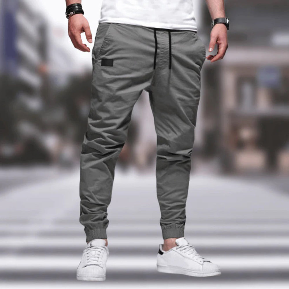 Grå joggebukser for menn, komfortabel passform, elastisk midje, snøring, moderne stil, perfekt for hverdagsbruk og fritidsaktiviteter.
